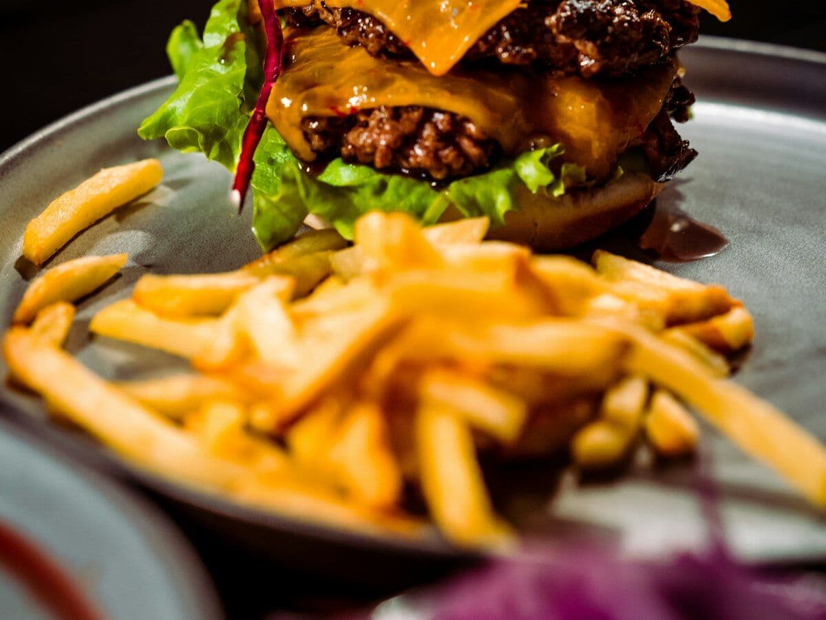 A double smash burger with cheese and fries